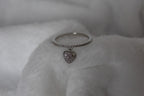 Ring with heart-shaped pendant